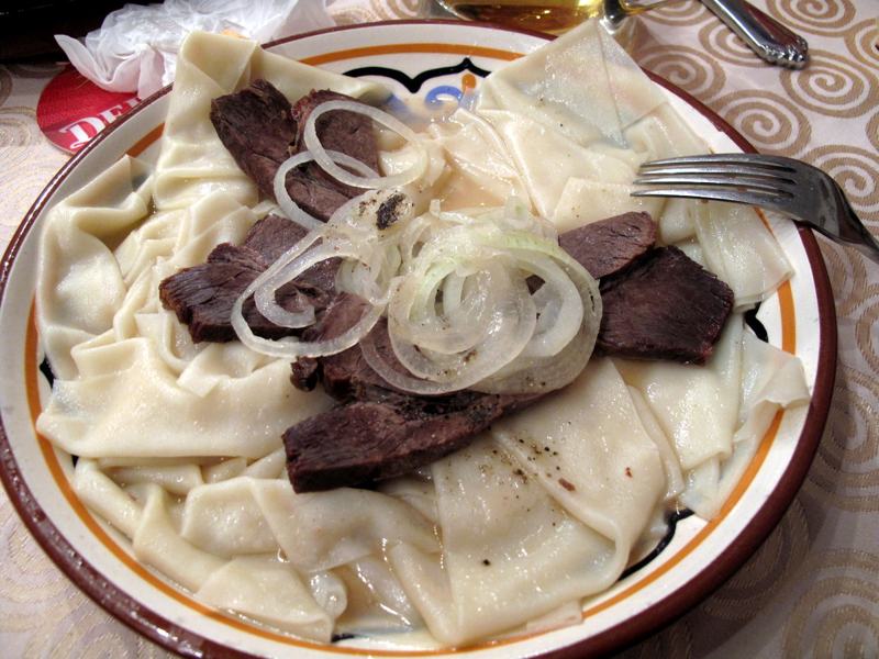 Beshbarmak served with horse meat and onions