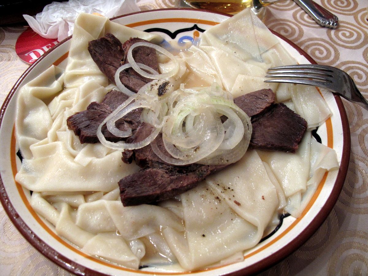 Beshbarmak served with horse meat and onions
