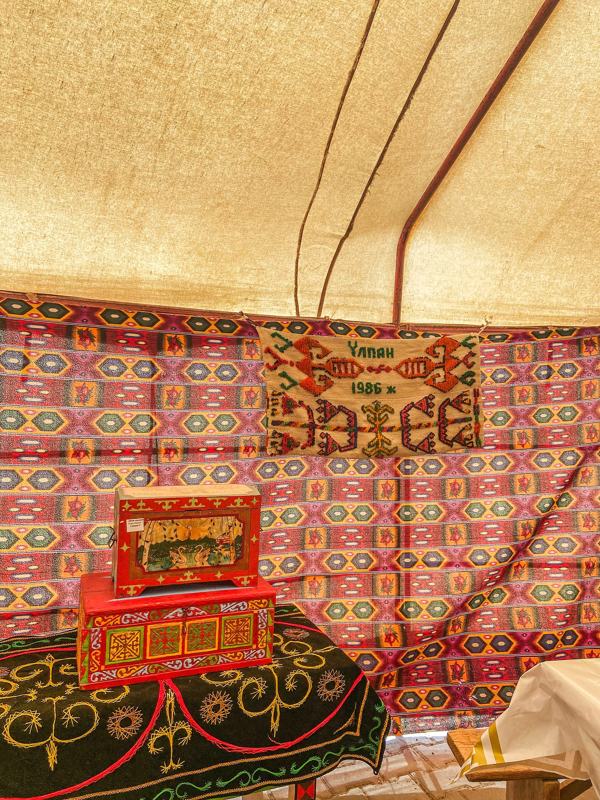 Felt carpets and painted chests inside a Kazakh yurt