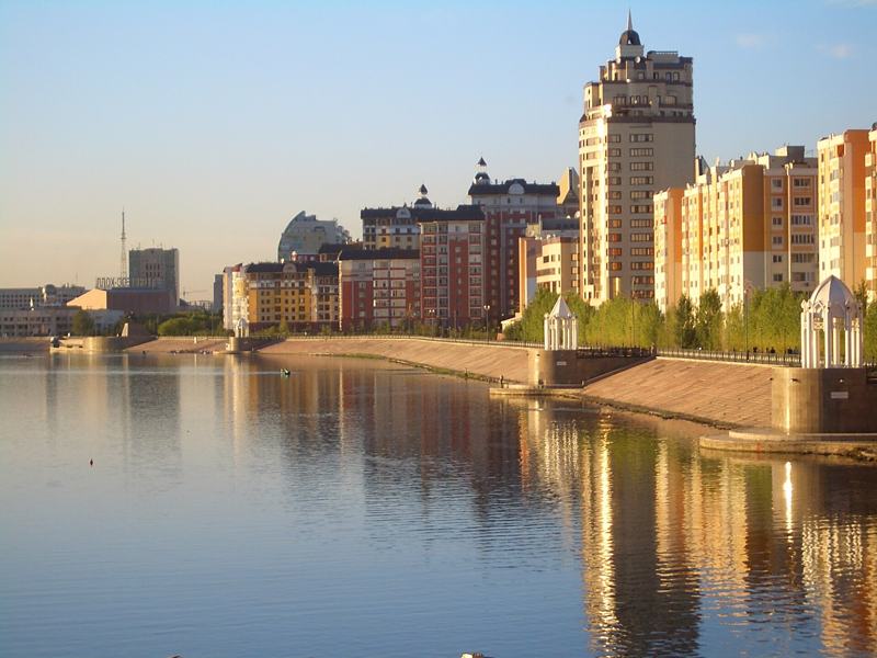 Astana skyline reflected in the Ishim river embankment