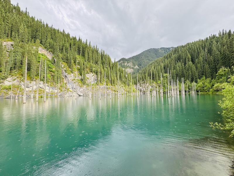 Lake Kaindy after rain, the water turned emerald green